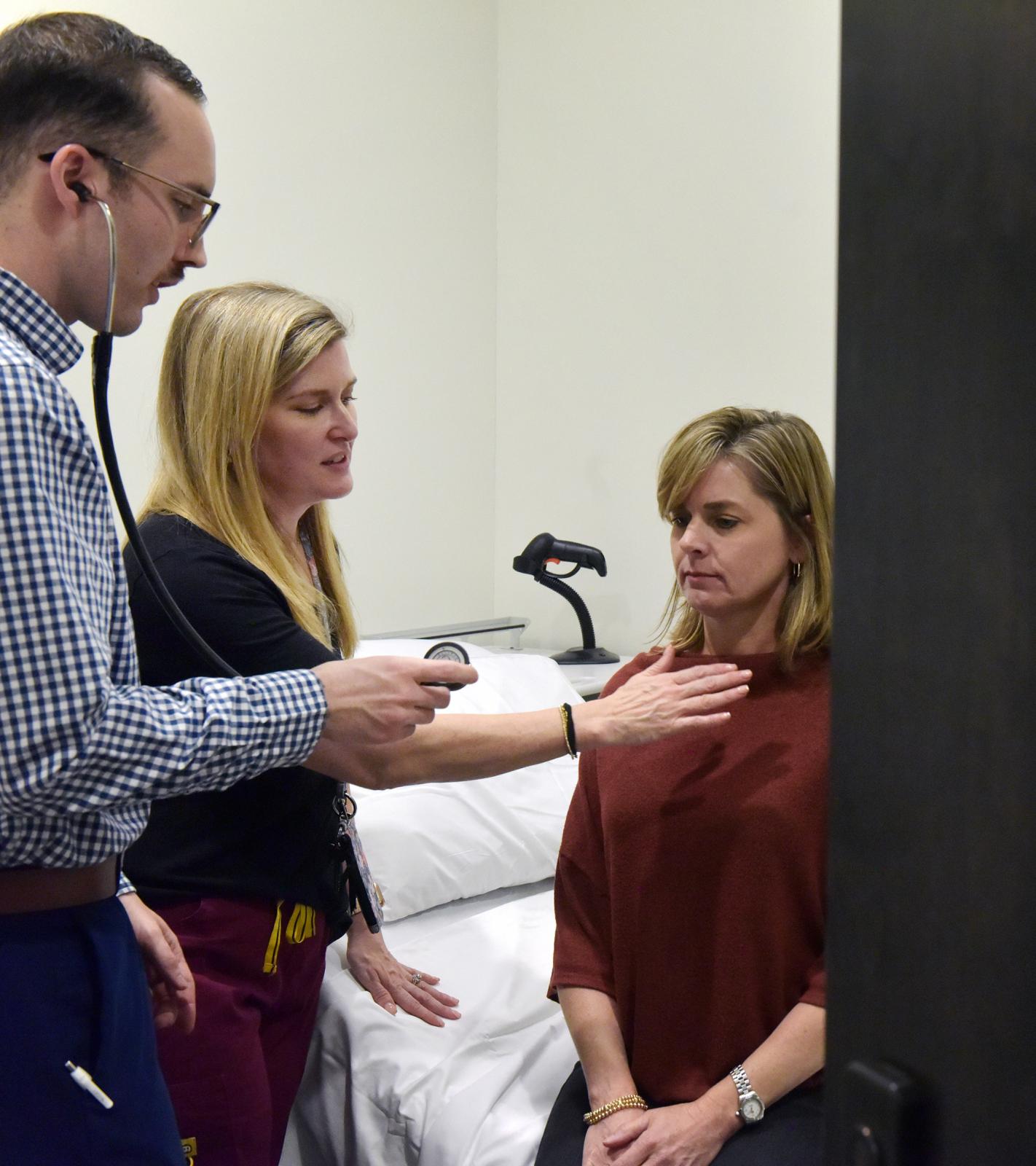 Alaina Herrington works in the Interprofessional Simulation Lab with Tyler Tyree, a PA student, and Standardized Patient Cassie Carroll. (Photo by Marianne Todd)