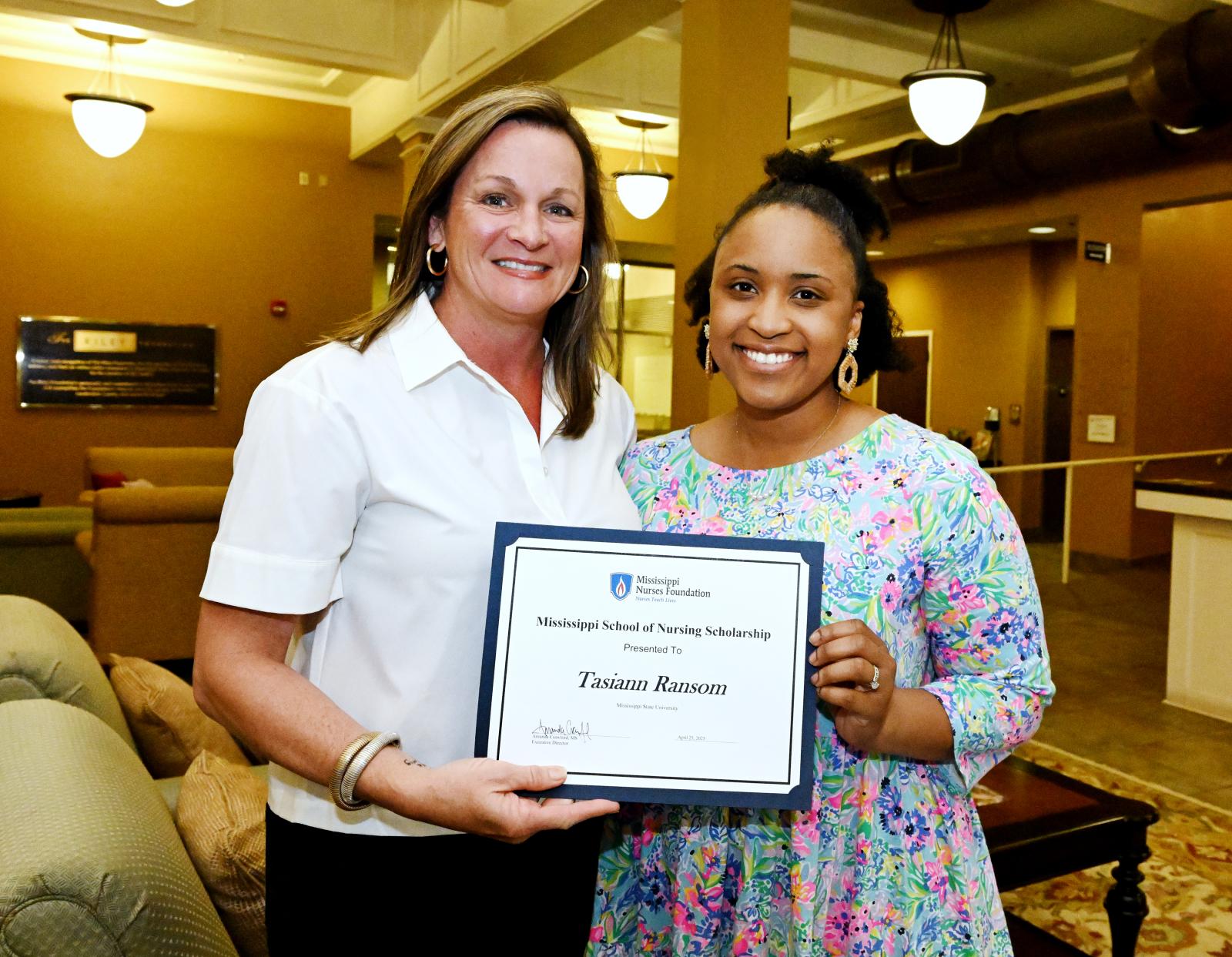 Amanda Crawford, executive director of the Mississippi Nurses Foundation, presents Tasi Ransom with a scholarship for her exemplary leadership. Ransom is the second nurse in MSU’s inaugural School of Nursing cohort to receive the foundation’s scholarship. (Photo submitted)