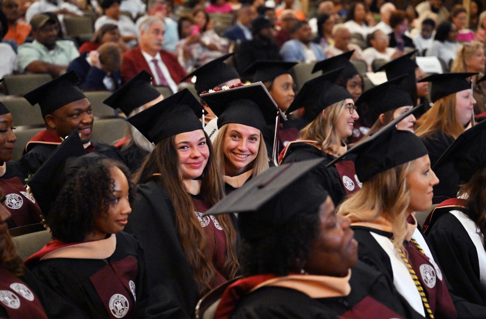 From left: Alexis Lowrey of Philadelphia and Emma Pitman of Dayton, Ohio, enjoy a moment during MSN graduation ceremonies held Thursday [Aug. 7] at the MSU Riley Center in downtown Meridian. (Photo by Marianne Todd)