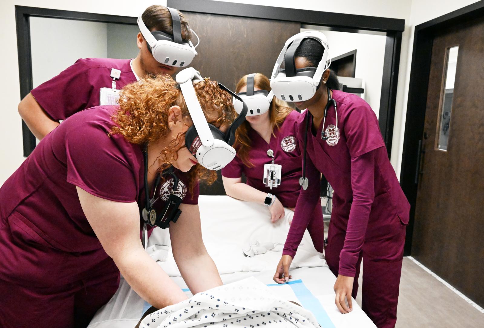 MSU-Meridian MSN students (from left to right), Joshua Shearon, Jessica Swindle, Skylar Kline and Melony Robinson experience virtual childbirth during a simulation in the campus’ Interprofessional Simulation Center. (Photograph by Marianne Todd).