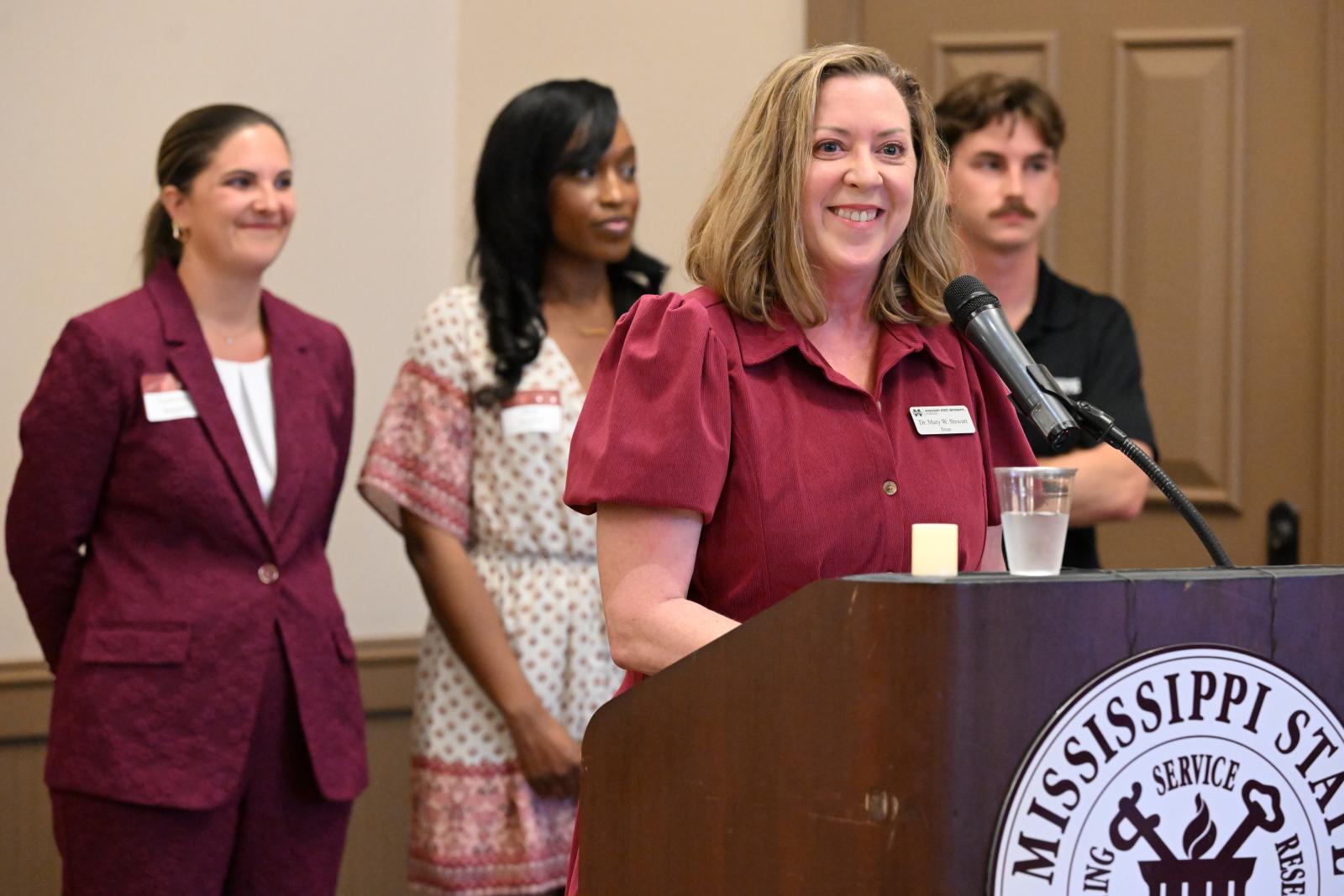 MSU PHOTO ID: Mississippi State University-Meridian School of Nursing Dean Mary Stewart addresses donors during a recent reception honoring their gifts in providing nursing students with scholarships. Joining her are nursing students, from left, Courtney Bounds of Philadelphia, Shatara Naylor of Meridian and Jackson DiCicco of Columbus, who shared how donor support has impacted their education. (Photo by Marianne Todd)