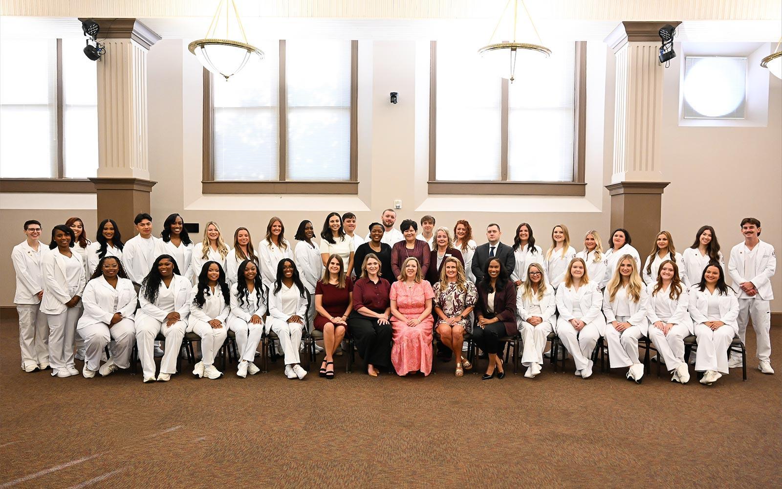 Mississippi State graduated its second cohort in the university’s Master of Science in Nursing program today [Aug. 6]. Students are pictured with MSU School of Nursing faculty leaders at the historic MSU Riley Center in downtown Meridian. (Photo by Grace Cockrell)