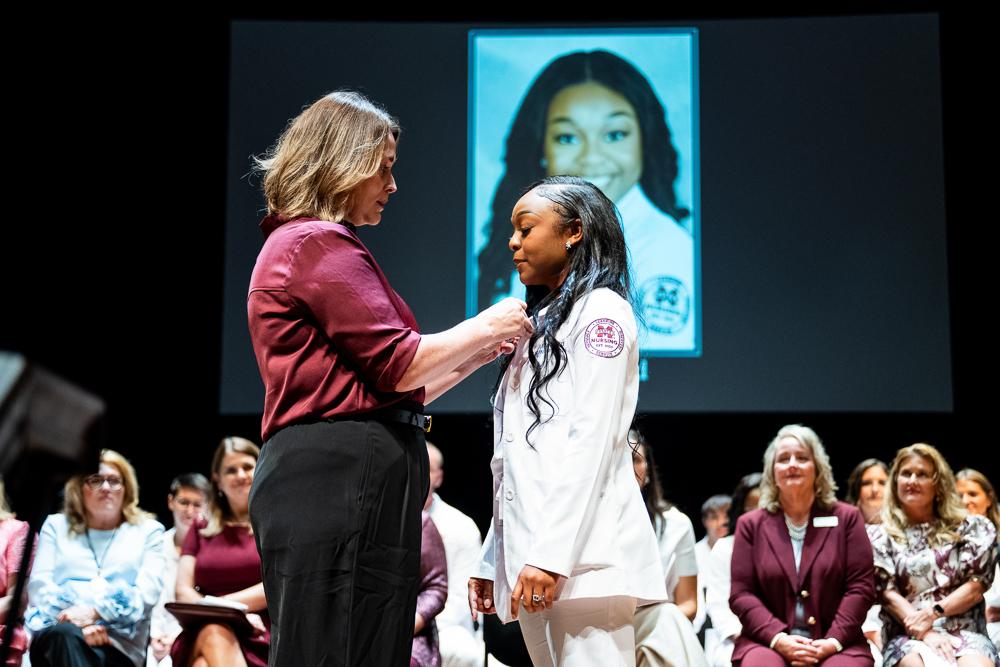 MSU Associate Dean and Master of Science in Nursing Program Director Kayla Carr pins Miriah Ford of Louisville, who completed her MSN degree this summer at MSU-Meridian. (Photo by Grace Cockrell)