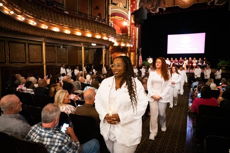 Jessyka Wansley of Newton leads as nursing students exit the historic MSU Riley Center following their pinning ceremony on graduation day. (Photo by Grace Cockrell)